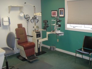 optometrists office with chair and equipment