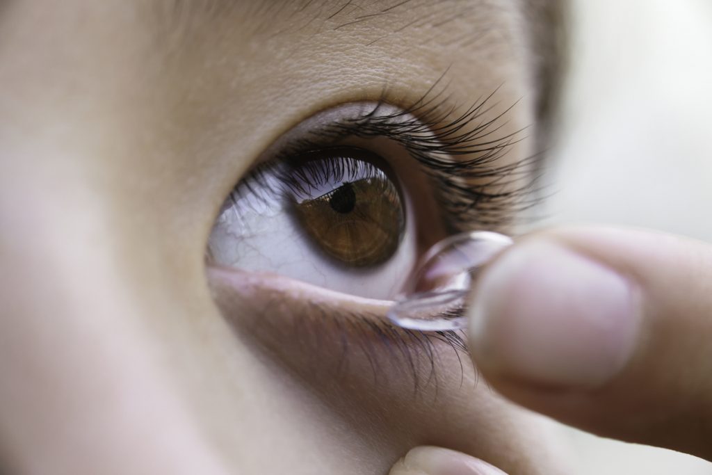 person putting in contact lens